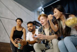 Four friends gaming enthusiastically inside a modern home, enjoying a lively moment. — Discover the Most Exciting MPO Gamblin