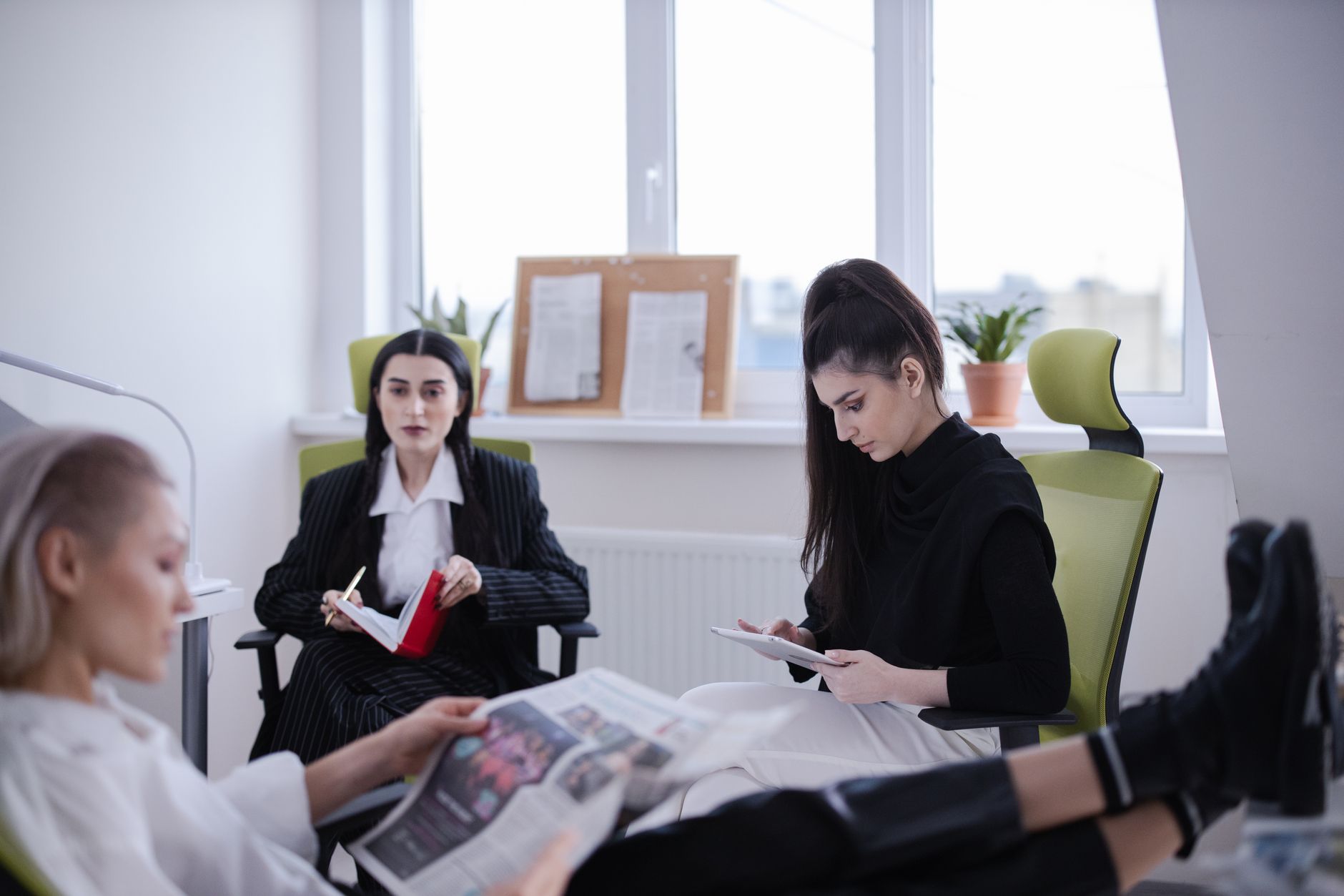 Three women in a modern office setting reading and working together indoors. — Healthspring Medicare Advantage in 2027: Your