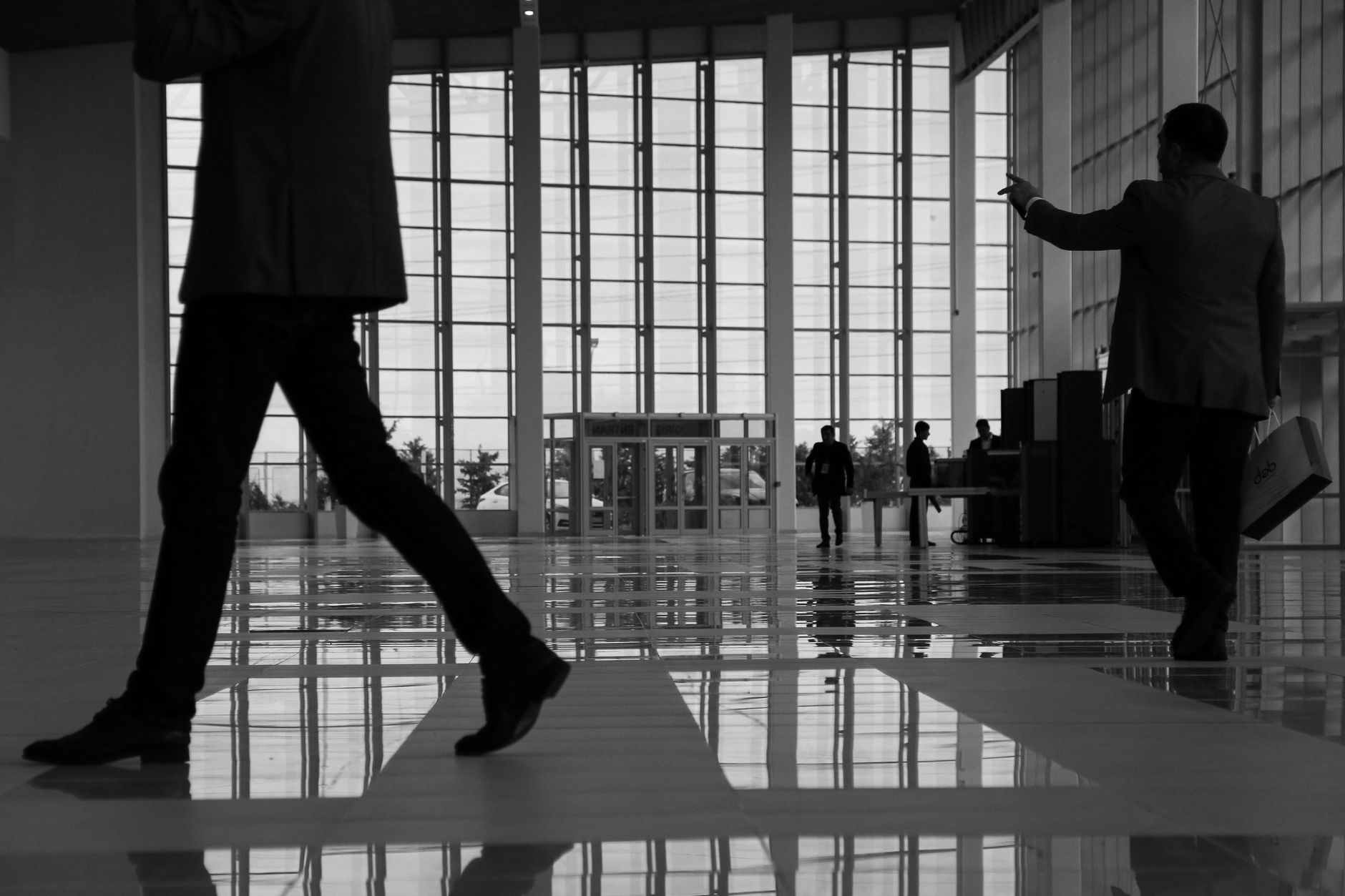 Business professionals walk through a modern, glass-paneled indoor space. — How Bree Montoya Balances CPA Expertise with Dedi