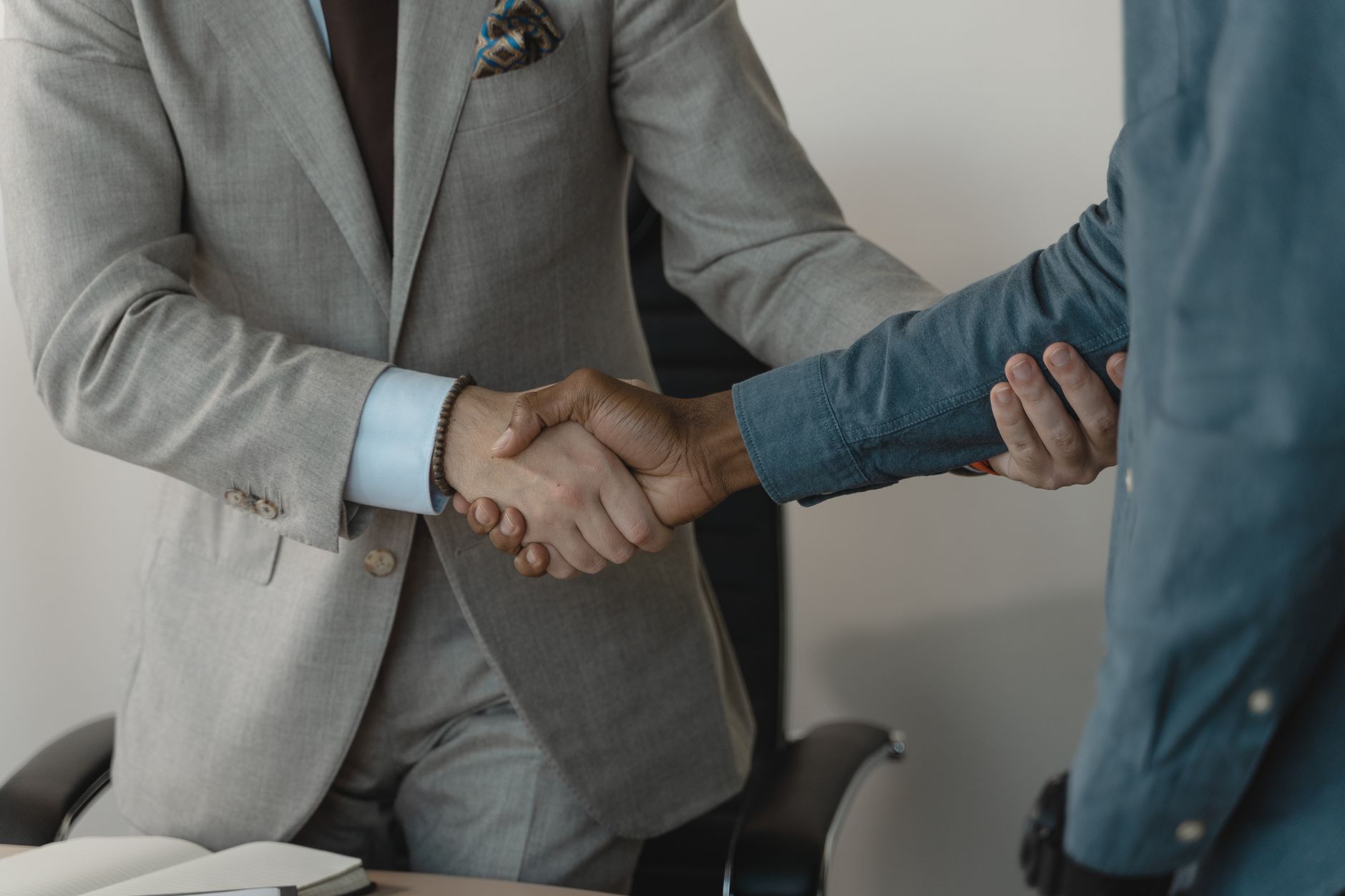 Image of a professional handshake between two businessmen in an office setting. — How Cape Town Hosts Elevate Guest Stays wit