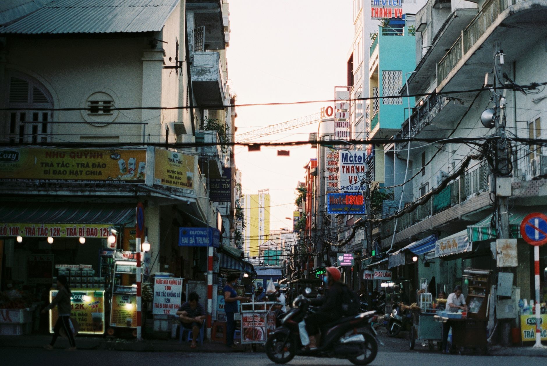 Colorful busy street scene in Cần Thơ, Vietnam with vibrant signs and people. — In-Home Care Santa Rosa - In-Home Care Santa