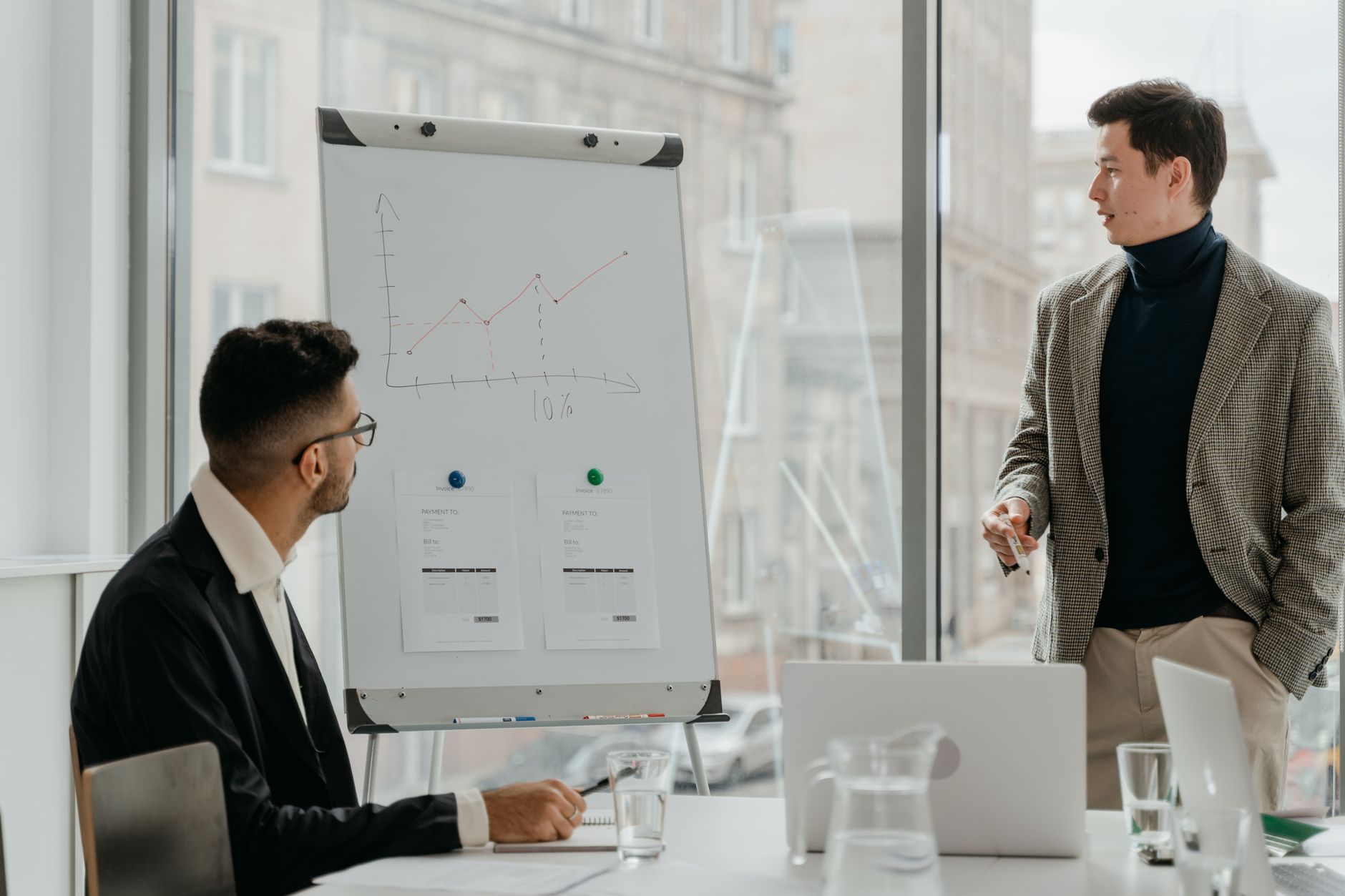 Professionals discussing a business chart in a modern office. — IPTV Danish Packages with Local and Global Content