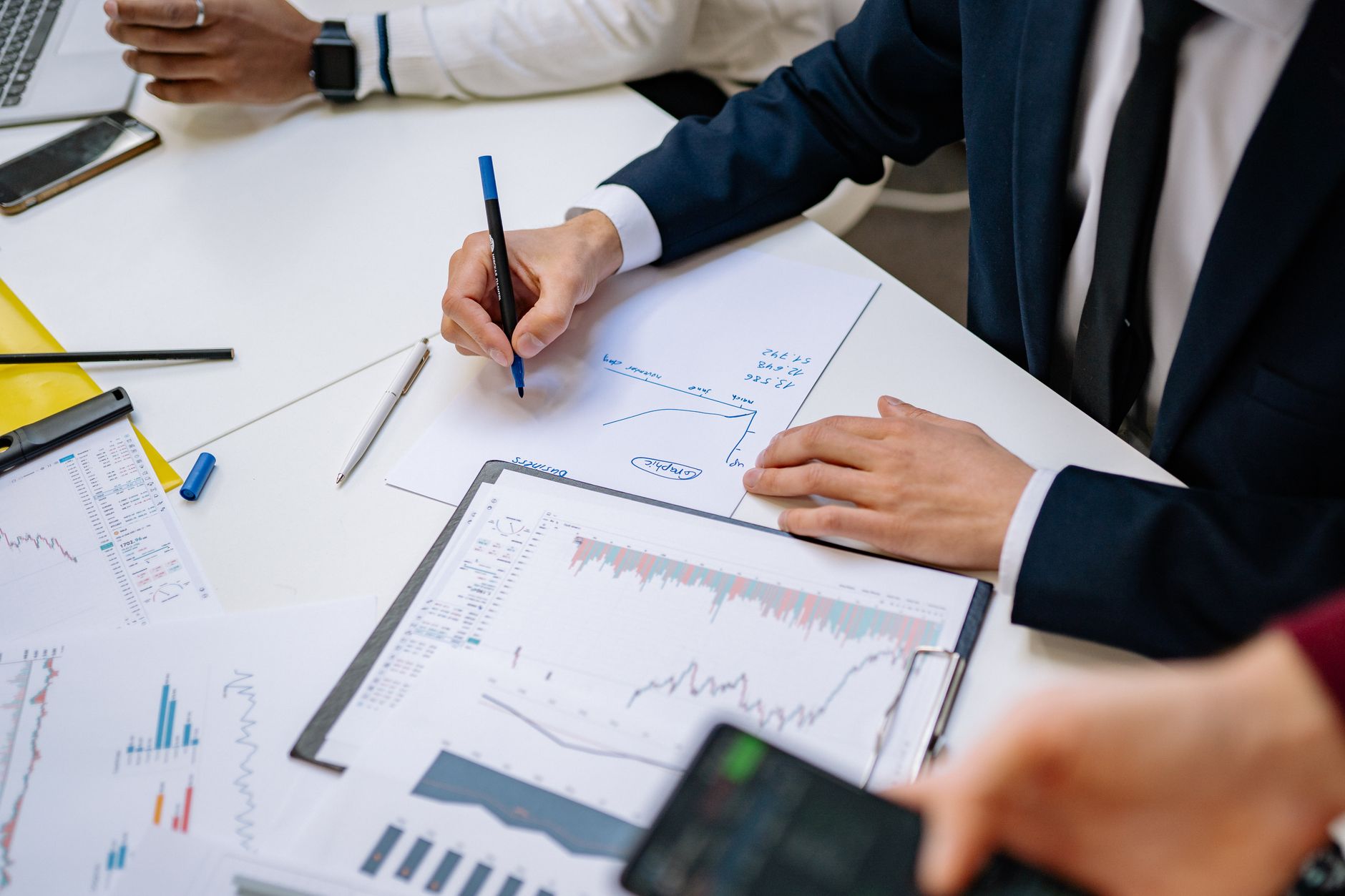 Professionals analyzing financial charts in a corporate setting. — Track Your Events and Goals with a Wall Planner